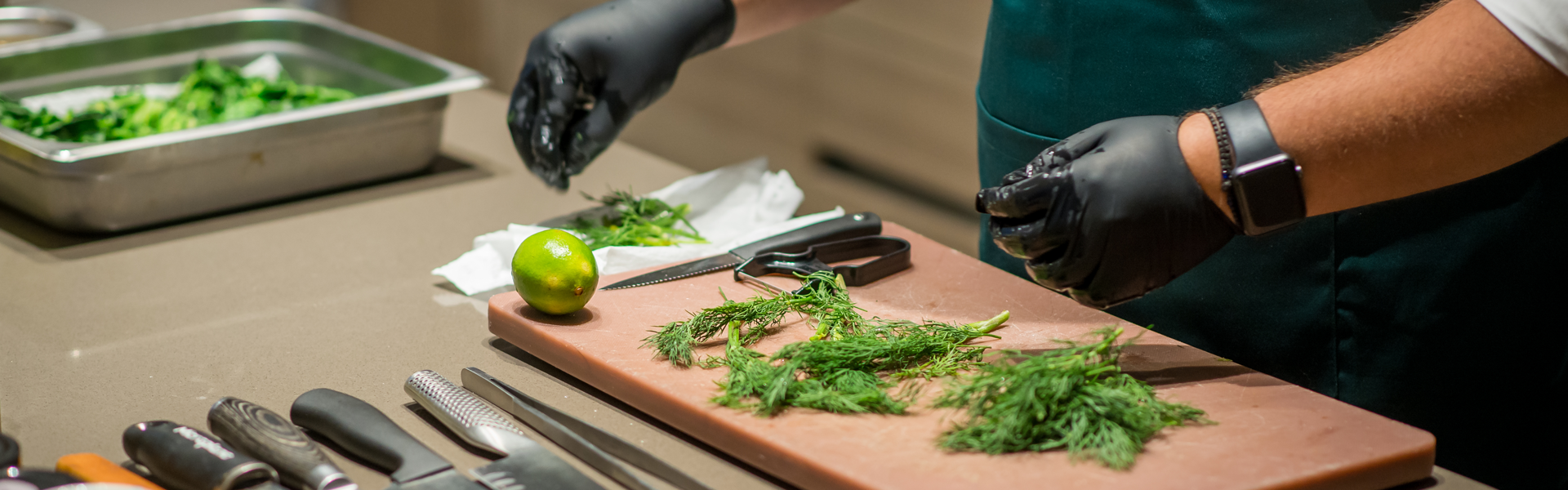 Private chef preparing fresh herbs for luxury villa dining in Paros, Greece.